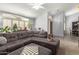 Bright living room featuring a comfortable gray sectional sofa, natural light, and stylish ceiling fan at 3602 W Barcelona Dr, Chandler, AZ 85226