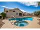 Backyard pool with integrated spa, tanning deck, and lush landscaping, perfect for outdoor living at 3602 W Barcelona Dr, Chandler, AZ 85226