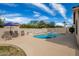 Inviting backyard pool with a tanning deck, lounge chairs, and an umbrella for shade and comfort at 3602 W Barcelona Dr, Chandler, AZ 85226