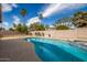 Sparkling pool with a tanning ledge, perfect for relaxation and outdoor enjoyment on a sunny day at 3602 W Barcelona Dr, Chandler, AZ 85226