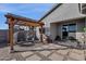 Landscaped backyard featuring a pergola with outdoor seating area at 36243 W San Clemente Ave, Maricopa, AZ 85138