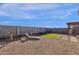 Spacious backyard with decorative rock, pavers, lawn and seating at 36243 W San Clemente Ave, Maricopa, AZ 85138