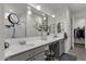 Bright bathroom featuring double sinks, ample counter space, and large mirror at 36243 W San Clemente Ave, Maricopa, AZ 85138