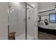 Modern bathroom with glass shower and wooden seat at 36243 W San Clemente Ave, Maricopa, AZ 85138