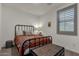 Cozy bedroom with rustic decor, bedside table, and shuttered windows at 36243 W San Clemente Ave, Maricopa, AZ 85138