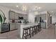 Spacious kitchen featuring an island with seating, modern appliances, and stylish pendant lights at 36243 W San Clemente Ave, Maricopa, AZ 85138