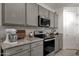 Modern kitchen with stainless steel appliances, granite countertops, and stylish backsplash at 36243 W San Clemente Ave, Maricopa, AZ 85138