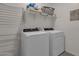 A well-organized laundry room featuring a modern washer and dryer set at 36243 W San Clemente Ave, Maricopa, AZ 85138