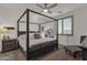 Serene main bedroom boasts a canopy bed, shuttered windows, and plush carpeting for comfort at 36243 W San Clemente Ave, Maricopa, AZ 85138