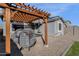 Backyard pergola featuring comfortable seating, perfect for relaxation and outdoor entertainment at 36243 W San Clemente Ave, Maricopa, AZ 85138