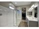 Modern bathroom featuring a glass-enclosed shower and double vanity sinks at 40789 W Shaver Dr, Maricopa, AZ 85138