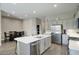 Bright kitchen featuring a center island, stainless appliances, and an adjacent dining area at 40789 W Shaver Dr, Maricopa, AZ 85138