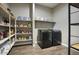 Pantry and laundry room with storage shelves and a modern washer and dryer at 40789 W Shaver Dr, Maricopa, AZ 85138