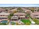 Aerial view of a home with a pool, outdoor kitchen, covered patio, and well-manicured lawn at 4297 S Marion Pl, Chandler, AZ 85249