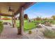 Covered backyard patio with desert landscaping, white rock ground cover and a manicured yard at 4297 S Marion Pl, Chandler, AZ 85249