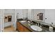 Bathroom featuring dual sinks, a granite countertop, and wood cabinets at 4297 S Marion Pl, Chandler, AZ 85249