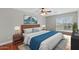 Bedroom with a ceiling fan, plantation shutters, wood floors, and two wall art pieces at 4297 S Marion Pl, Chandler, AZ 85249