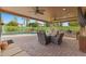 Expansive covered patio with a pool view, outdoor seating, and a built-in grilling area at 4297 S Marion Pl, Chandler, AZ 85249