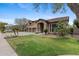 Beautifully landscaped front yard featuring mature trees, lush lawn, and a well-maintained garden at 4297 S Marion Pl, Chandler, AZ 85249