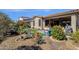 This serene backyard showcases meticulous landscaping, a synthetic lawn area, and a view of the home's exterior at 4483 E Sourwood Dr, Gilbert, AZ 85298