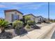 Beautiful single-story home featuring manicured landscaping, neutral colors, and brick-lined driveway at 4483 E Sourwood Dr, Gilbert, AZ 85298