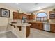 Kitchen with breakfast bar, warm wood cabinets and stainless appliances and fixtures at 4483 E Sourwood Dr, Gilbert, AZ 85298