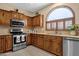 This beautiful kitchen boasts warm wood cabinetry and stainless appliances and fixtures at 4483 E Sourwood Dr, Gilbert, AZ 85298