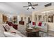 Spacious living room features a ceiling fan, neutral walls, and views into the adjacent kitchen and dining area at 4483 E Sourwood Dr, Gilbert, AZ 85298