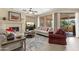 Bright living room featuring a fireplace, ceiling fan, and sliding doors to outdoor living space at 4483 E Sourwood Dr, Gilbert, AZ 85298