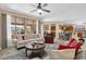 Living room with fireplace, ceiling fan, and view to an outdoor patio and kitchen at 4483 E Sourwood Dr, Gilbert, AZ 85298