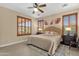 Bright main bedroom features plantation shutters, a ceiling fan, and neutral color palettes at 4483 E Sourwood Dr, Gilbert, AZ 85298