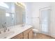 Bright bathroom with double sinks, tile floor, and an exterior door for convenience at 5125 W Wikieup Ln, Glendale, AZ 85308