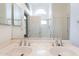 Bathroom featuring double sinks, a shower, and a bright, airy atmosphere at 5125 W Wikieup Ln, Glendale, AZ 85308