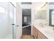 A partial view of a bathroom with double sinks and a view into the main bedroom at 5125 W Wikieup Ln, Glendale, AZ 85308