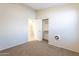 This bedroom has neutral walls, carpet, closet, and a fan at 5125 W Wikieup Ln, Glendale, AZ 85308