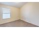 This bedroom features neutral-toned walls, carpet, and a window with blinds at 5125 W Wikieup Ln, Glendale, AZ 85308