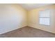 Small bedroom featuring a window allowing natural light and neutral toned walls at 5125 W Wikieup Ln, Glendale, AZ 85308