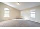 Bedroom with neutral walls, carpet flooring, and a doorway with arched window above at 5125 W Wikieup Ln, Glendale, AZ 85308