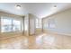 Living room with neutral walls, tile flooring, and a door leading to the outside at 5125 W Wikieup Ln, Glendale, AZ 85308