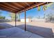 Expansive backyard with a covered patio, palm trees, and plenty of space for outdoor activities at 516 E Mesquite Ave, Apache Junction, AZ 85119