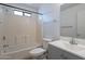 Bathroom featuring a shower-tub combo with light tile surround, complemented by a vanity with light gray cabinets at 516 E Mesquite Ave, Apache Junction, AZ 85119