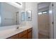 Bathroom featuring a wood vanity sink with mirror, with shower-tub visible through the open doorway at 516 E Mesquite Ave, Apache Junction, AZ 85119