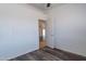 Bright bedroom featuring modern wood flooring, view into the hall and ceiling fan at 516 E Mesquite Ave, Apache Junction, AZ 85119