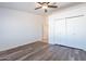 Bedroom featuring modern flooring, a ceiling fan, and a closet for ample storage space at 516 E Mesquite Ave, Apache Junction, AZ 85119