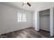 A well-lit bedroom featuring modern flooring, a ceiling fan, and a closet for ample storage space at 516 E Mesquite Ave, Apache Junction, AZ 85119