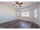 Bright bedroom offers lots of natural light, enhanced by modern flooring and a ceiling fan at 516 E Mesquite Ave, Apache Junction, AZ 85119