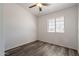 Clean bedroom features wood floors, ceiling fan and natural light at 516 E Mesquite Ave, Apache Junction, AZ 85119