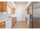 Bright kitchen featuring wooden cabinets, dual sink, dishwasher and stainless steel refrigerator appliance at 516 E Mesquite Ave, Apache Junction, AZ 85119