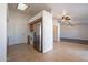 Kitchen with tile flooring, white walls, stainless steel refrigerator, and open floor plan at 516 E Mesquite Ave, Apache Junction, AZ 85119