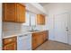 Kitchen featuring wooden cabinets, large sink and white dishwasher appliance at 516 E Mesquite Ave, Apache Junction, AZ 85119